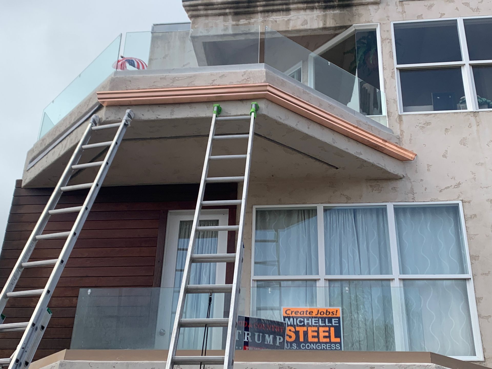 Pacific Coast Seamless crew installing custom gutters